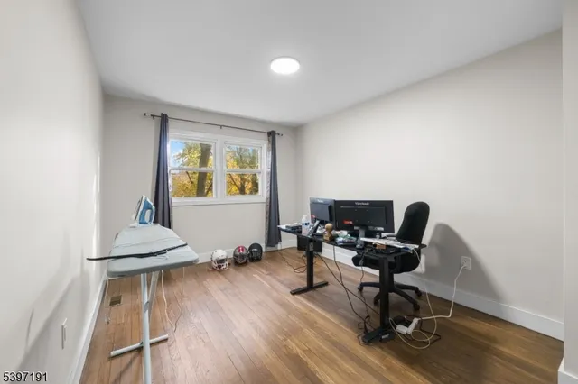 a view of workspace with wooden floor windows