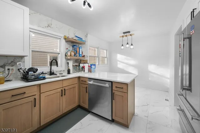 a kitchen with stainless steel appliances a sink and cabinets