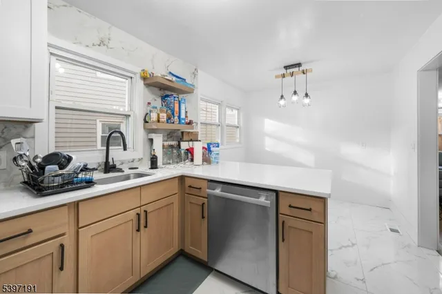 a kitchen with cabinets and window