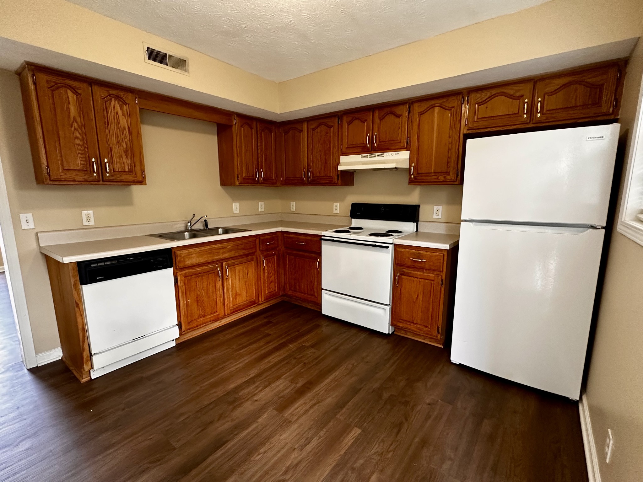 114 Emily Lane, Unit A Portland, TN 37148 - Photo 7 of 15 a kitchen with stainless steel appliances granite countertop white cabinets a refrigerator a sink a stove a microwave and wooden floors
