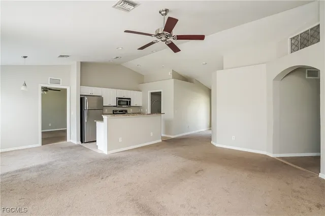 a view of a kitchen with a sink and refrigerator