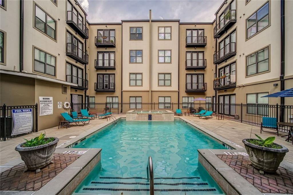 5300 Peachtree Road, Unit 2604 Atlanta, GA 30341 - Photo 3 of 39 a view of a swimming pool with a lounge chair