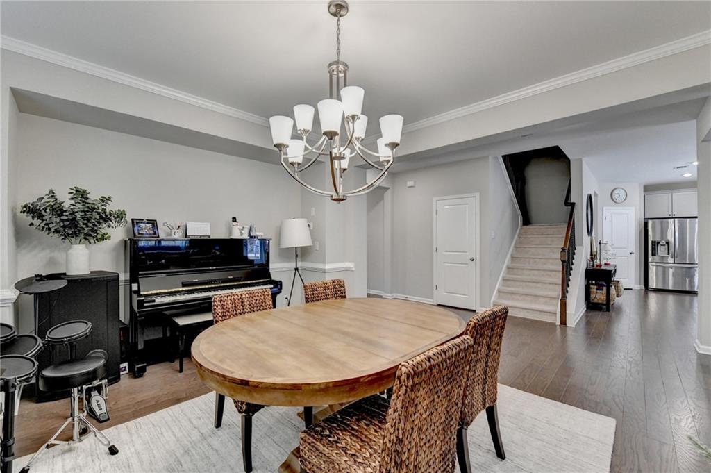 955 Laura Jean Court Buford, GA 30518 - Photo 11 of 68 a view of a dining room with furniture and wooden floor