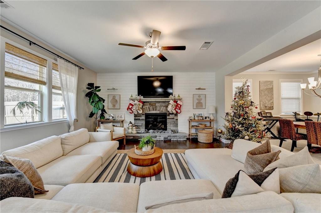 955 Laura Jean Court Buford, GA 30518 - Photo 16 of 68 a living room with furniture a fireplace and a flat screen tv