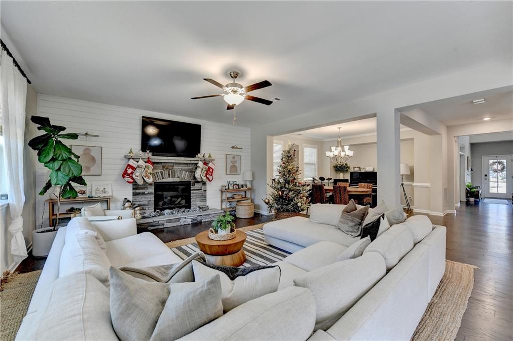 955 Laura Jean Court Buford, GA 30518 - Photo 17 of 68 a living room with furniture a fireplace and a flat screen tv
