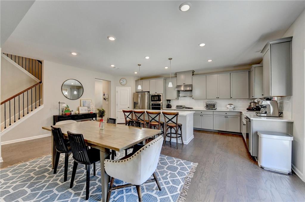 955 Laura Jean Court Buford, GA 30518 - Photo 19 of 68 a large kitchen with a table and chairs