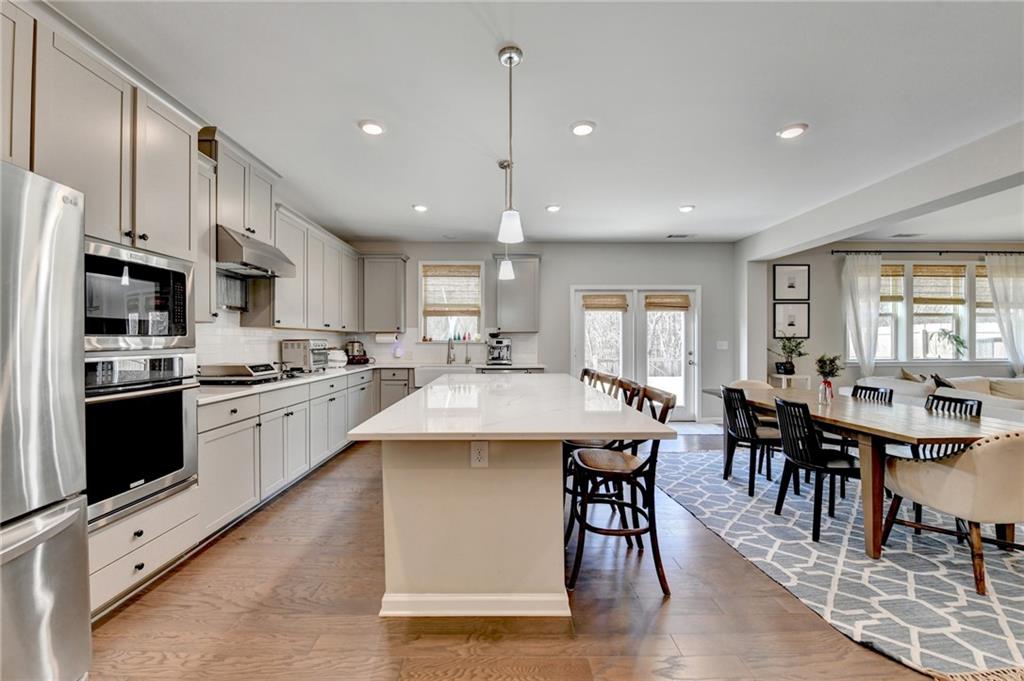 955 Laura Jean Court Buford, GA 30518 - Photo 28 of 68 a large kitchen with kitchen island a island in the center