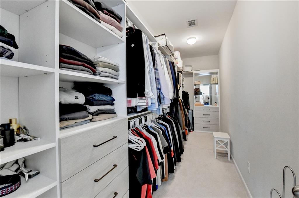 955 Laura Jean Court Buford, GA 30518 - Photo 35 of 68 a view of walk in closet with clothes and shoes