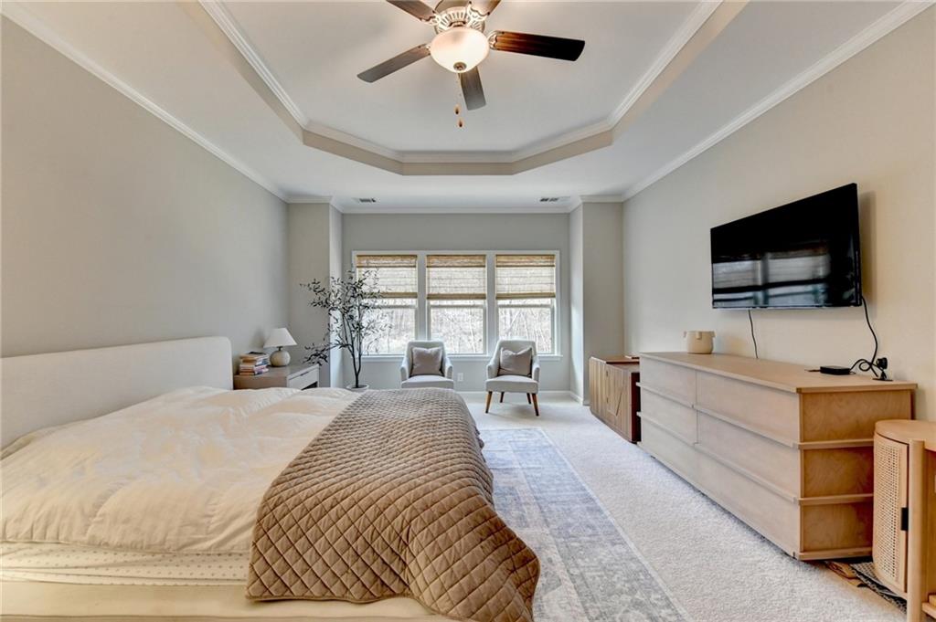 955 Laura Jean Court Buford, GA 30518 - Photo 37 of 68 a spacious bedroom with a bed and a flat screen tv