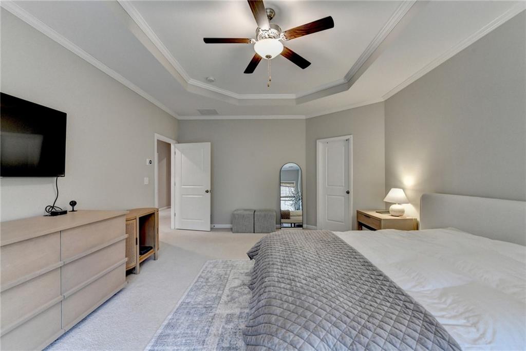 955 Laura Jean Court Buford, GA 30518 - Photo 39 of 68 a bedroom with bed and a flat tv screen on dresser