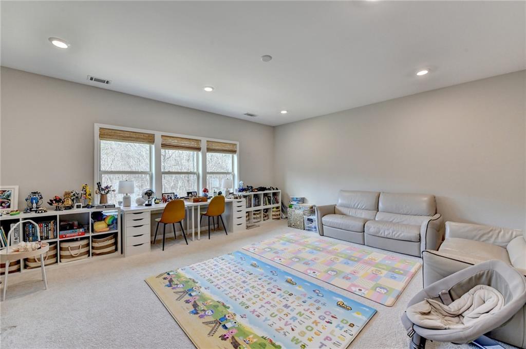 955 Laura Jean Court Buford, GA 30518 - Photo 44 of 68 a living room with furniture a rug and a table