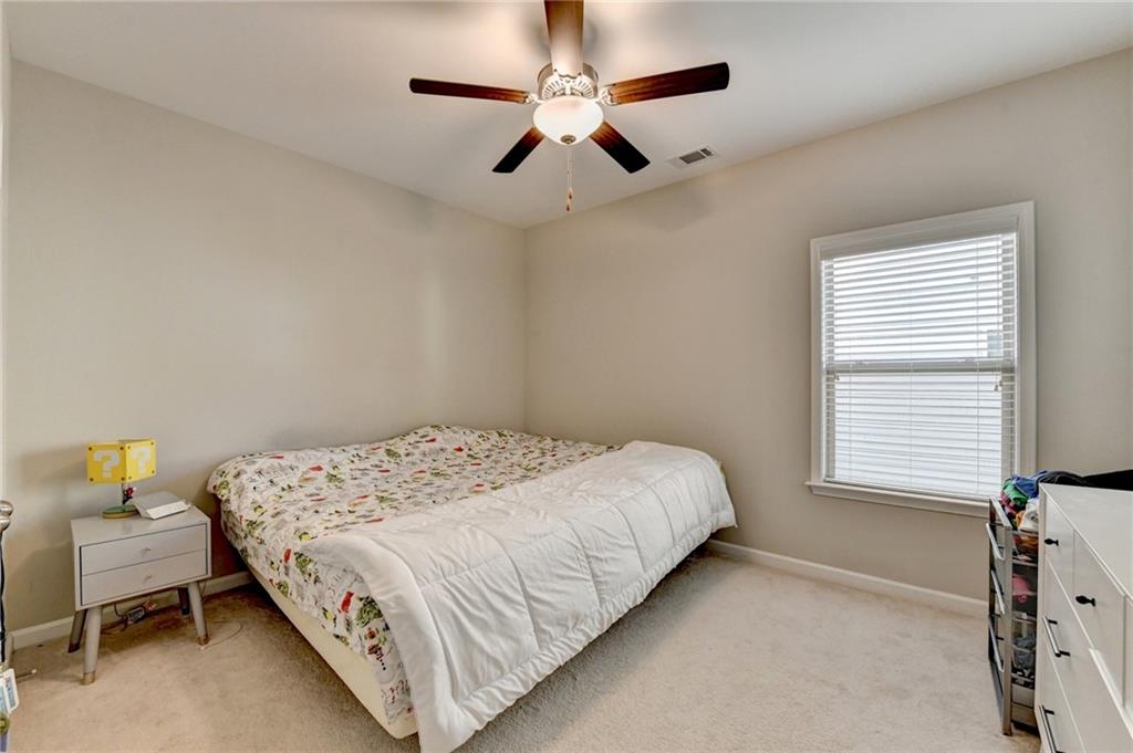 955 Laura Jean Court Buford, GA 30518 - Photo 49 of 68 a bedroom with a bed and a window