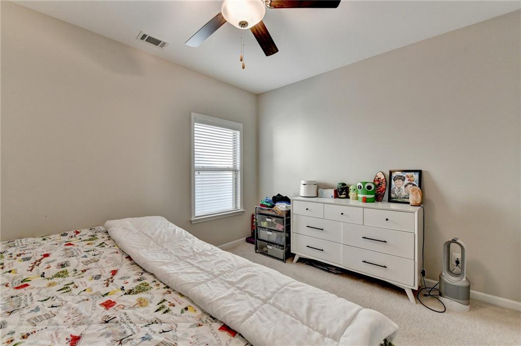 955 Laura Jean Court Buford, GA 30518 - Photo 51 of 68 a bedroom with a bed and window