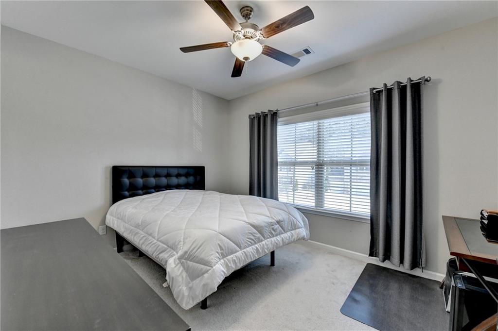 955 Laura Jean Court Buford, GA 30518 - Photo 55 of 68 a bed sitting in a bedroom next to a window