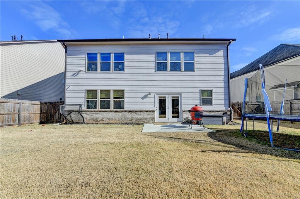 955 Laura Jean Court Buford, GA 30518 - Photo 66 of 68 a view of a house with backyard and sitting area