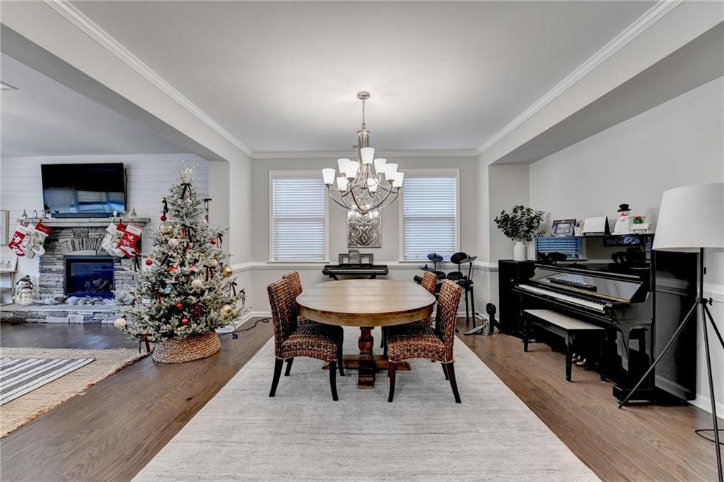 955 Laura Jean Court Buford, GA 30518 - Photo 8 of 68 a view of a dining room with furniture and wooden floor