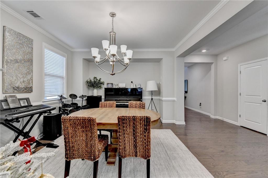 955 Laura Jean Court Buford, GA 30518 - Photo 10 of 68 a view of a dining room with furniture and chandelier