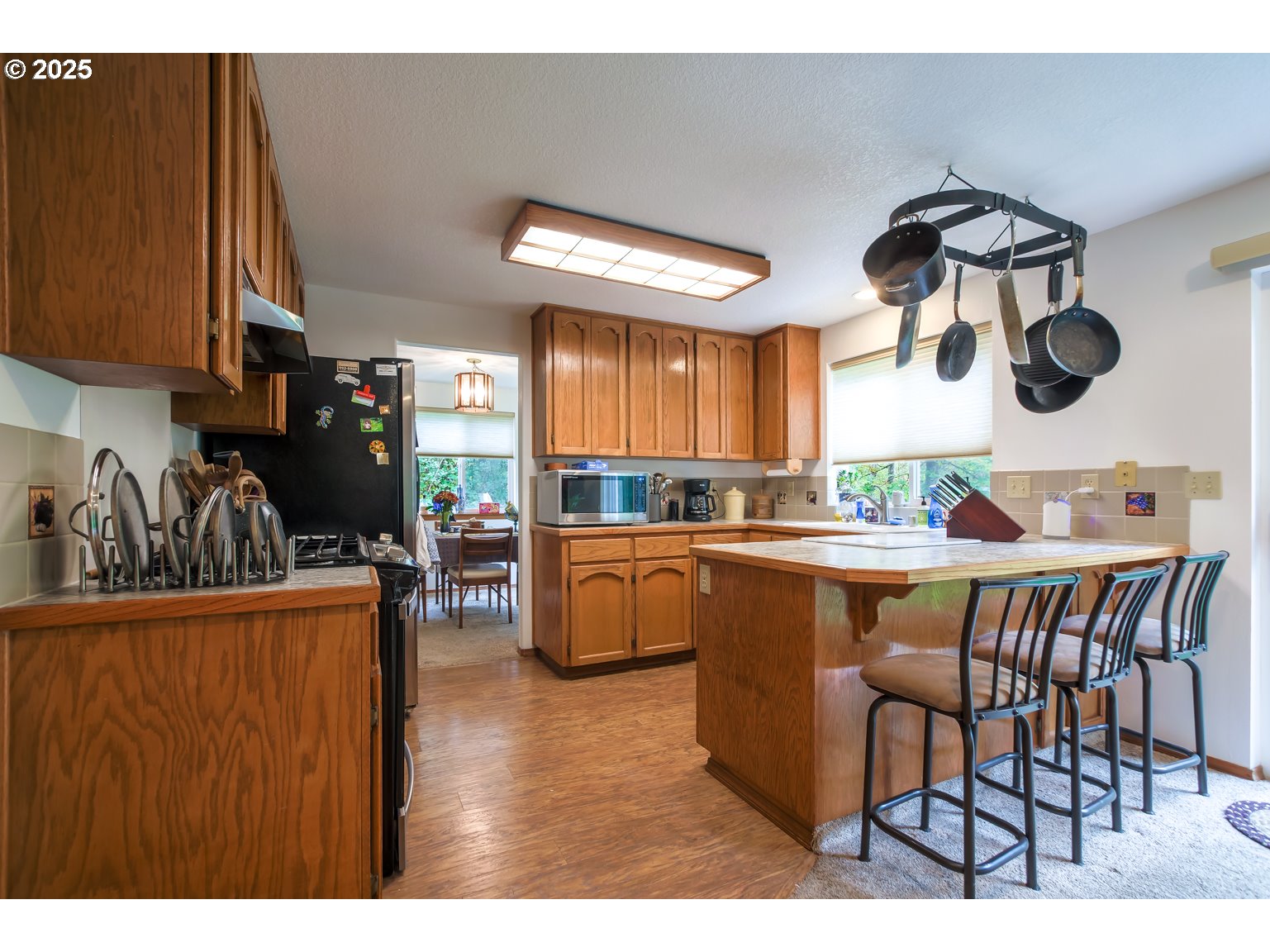 1809 Northwest 310th Street Ridgefield, WA 98642 - Photo 12 of 37 a kitchen with a table chairs stove and cabinets