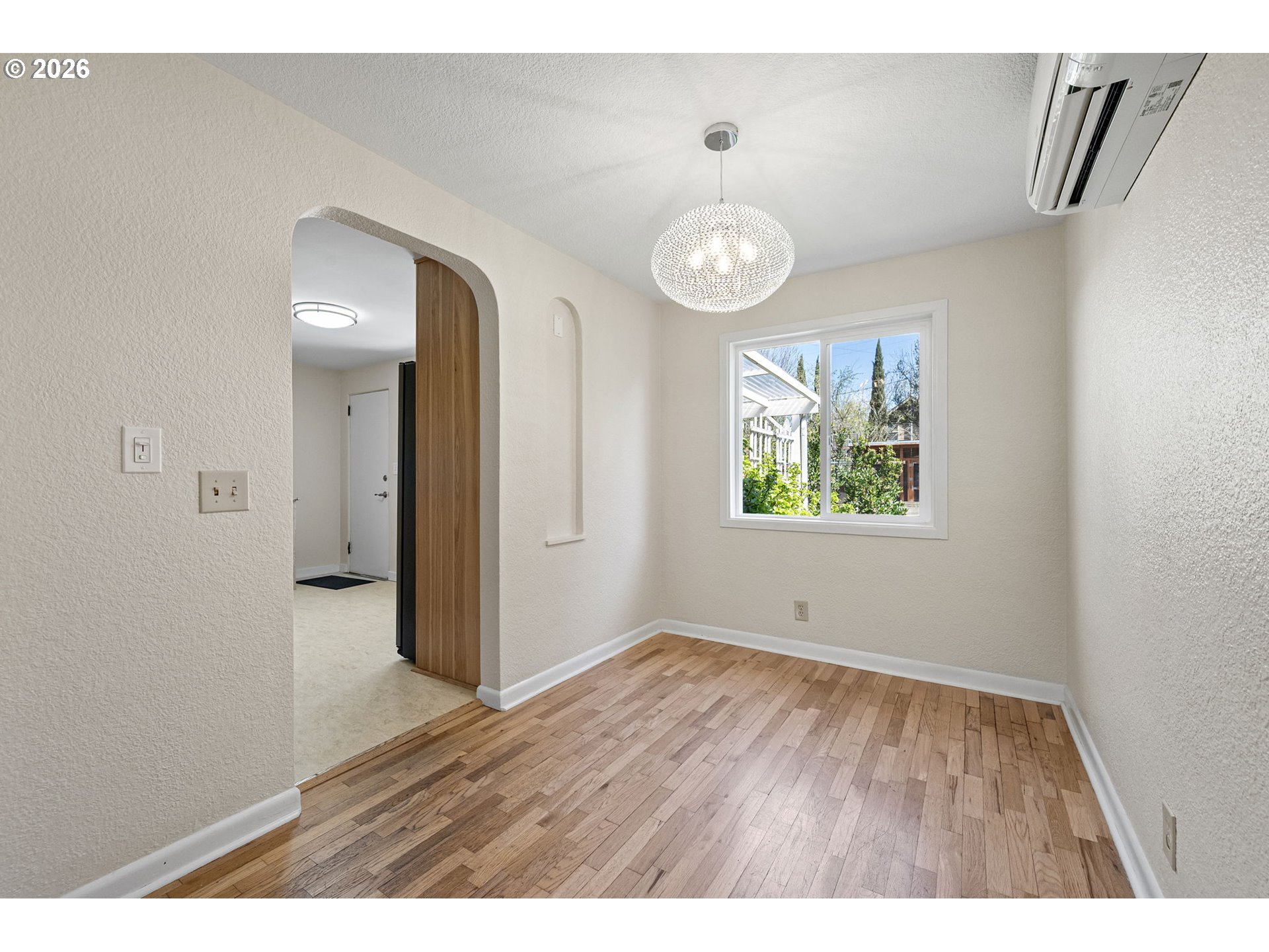 1255 Taylor Street Eugene, OR 97402 - Photo 13 of 48 a view of an empty room with window and wooden floor
