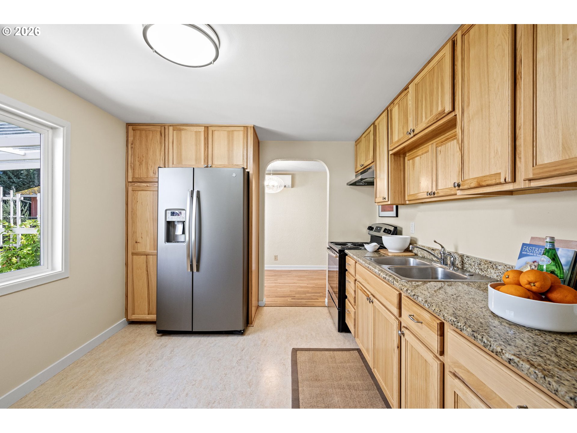 1255 Taylor Street Eugene, OR 97402 - Photo 16 of 48 a kitchen with stainless steel appliances granite countertop a refrigerator a sink a stove and a wooden cabinets