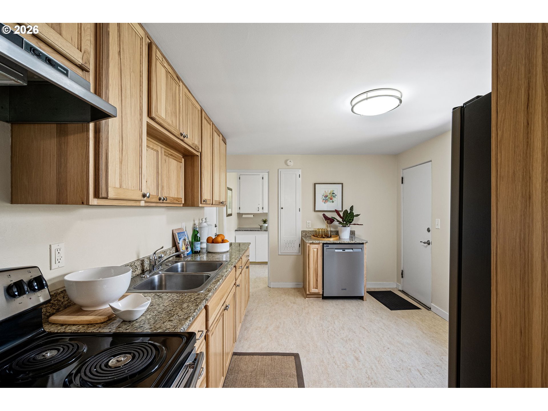 1255 Taylor Street Eugene, OR 97402 - Photo 17 of 48 a kitchen with a sink dishwasher a stove and a refrigerator with wooden floor