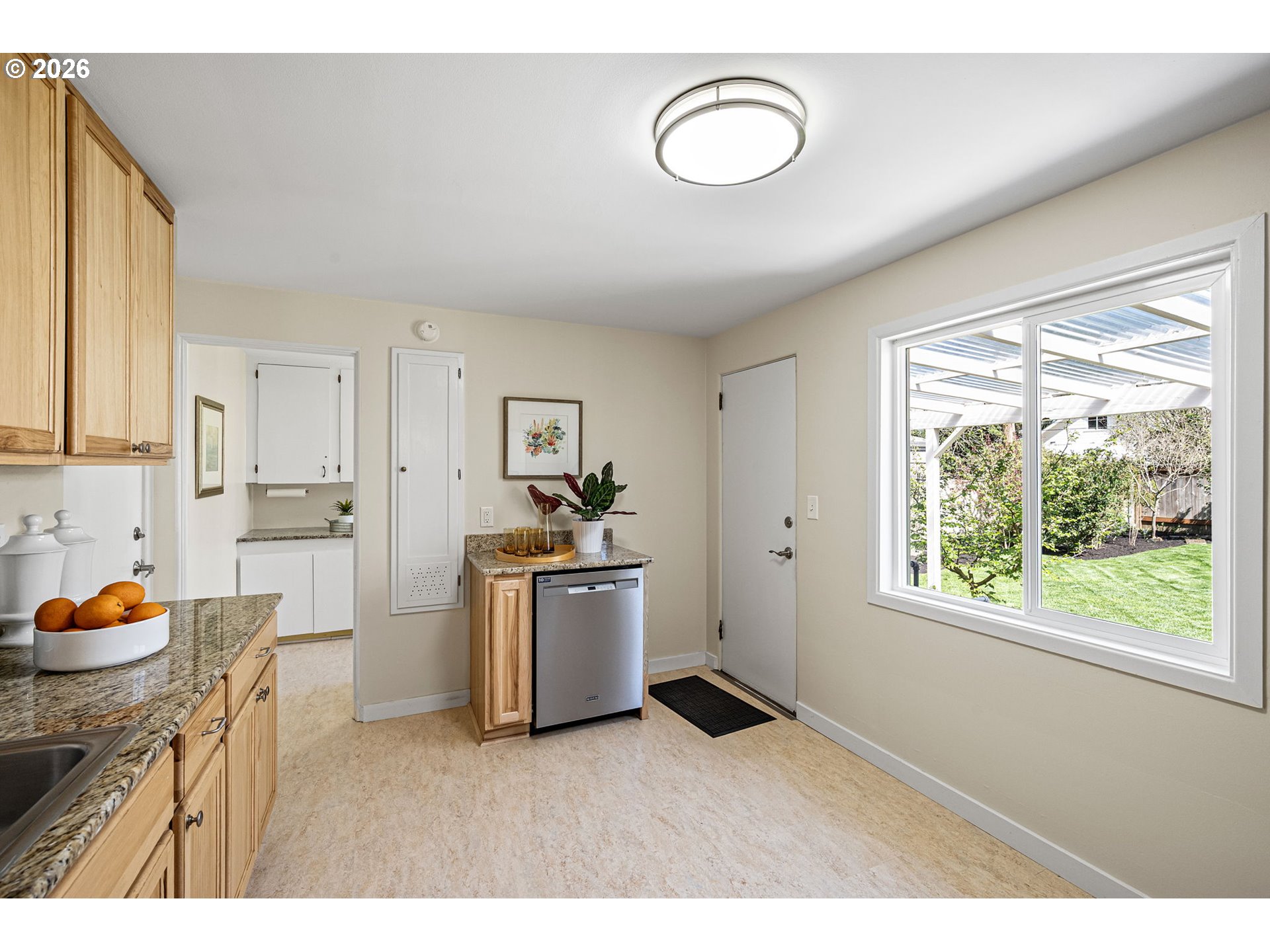 1255 Taylor Street Eugene, OR 97402 - Photo 19 of 48 a kitchen with cabinets wooden floor and a window