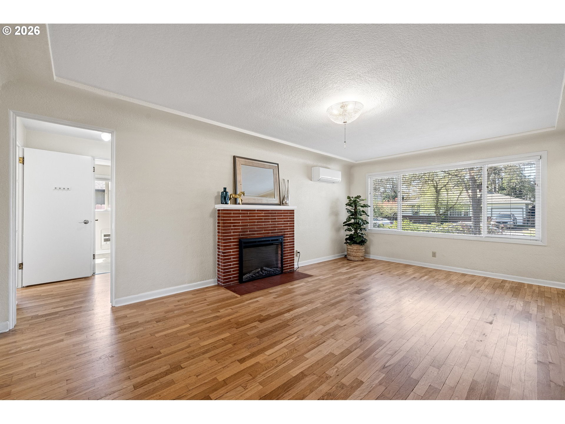 1255 Taylor Street Eugene, OR 97402 - Photo 5 of 48 a view of empty room with wooden floor and fireplace