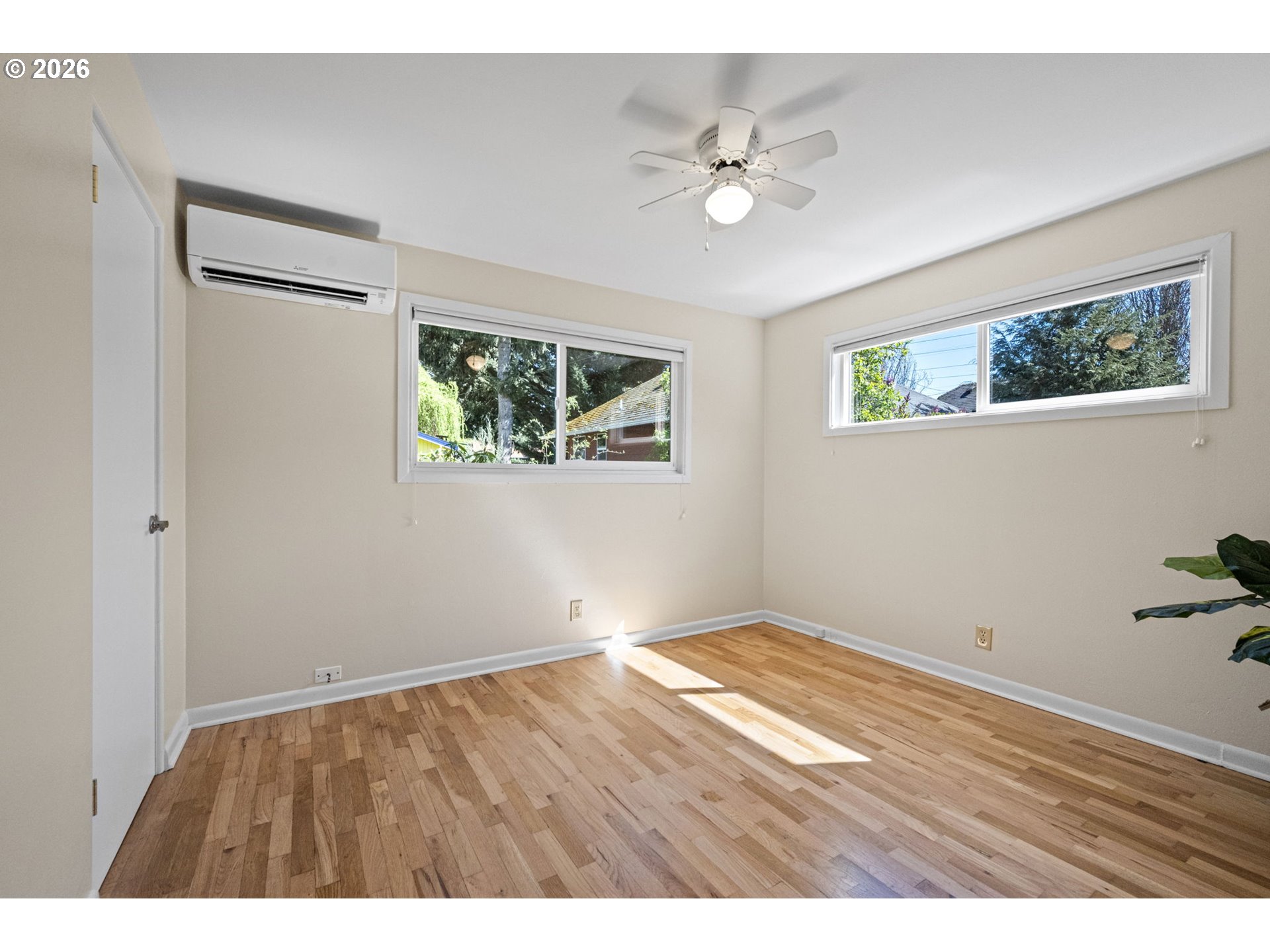 1255 Taylor Street Eugene, OR 97402 - Photo 7 of 48 a view of an empty room with wooden floor and a window