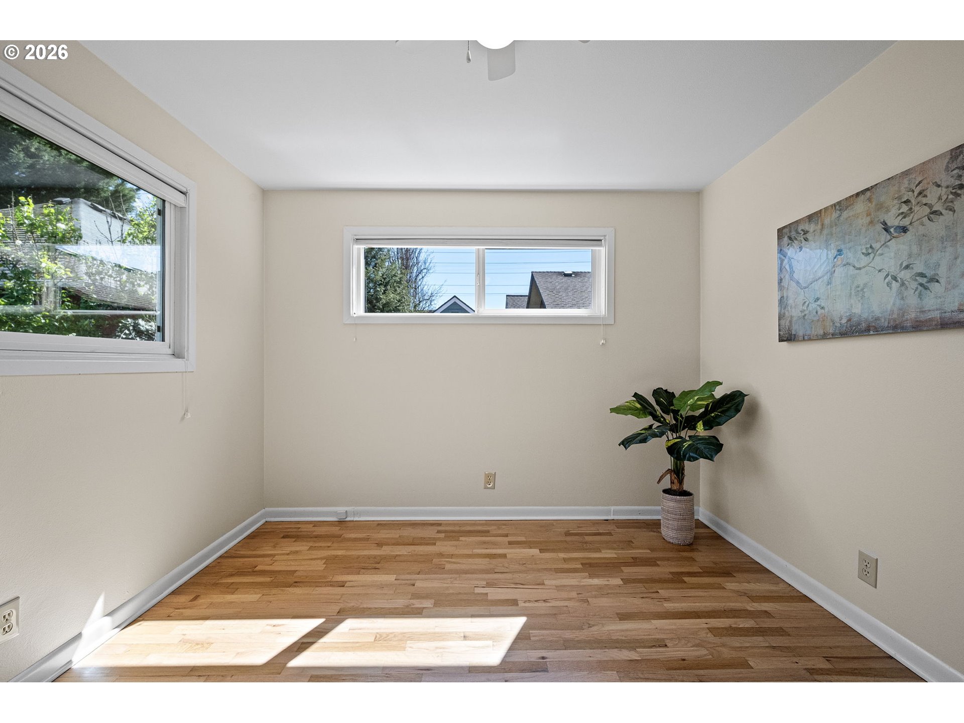 1255 Taylor Street Eugene, OR 97402 - Photo 8 of 48 a view of an empty room with wooden floor and a potted plant