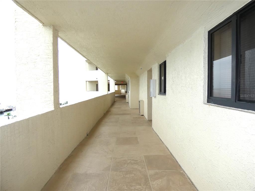 5915 Sea Ranch Drive, Unit 704 Hudson, FL 34667 - Photo 16 of 62 a view of a big room with wooden floor and windows