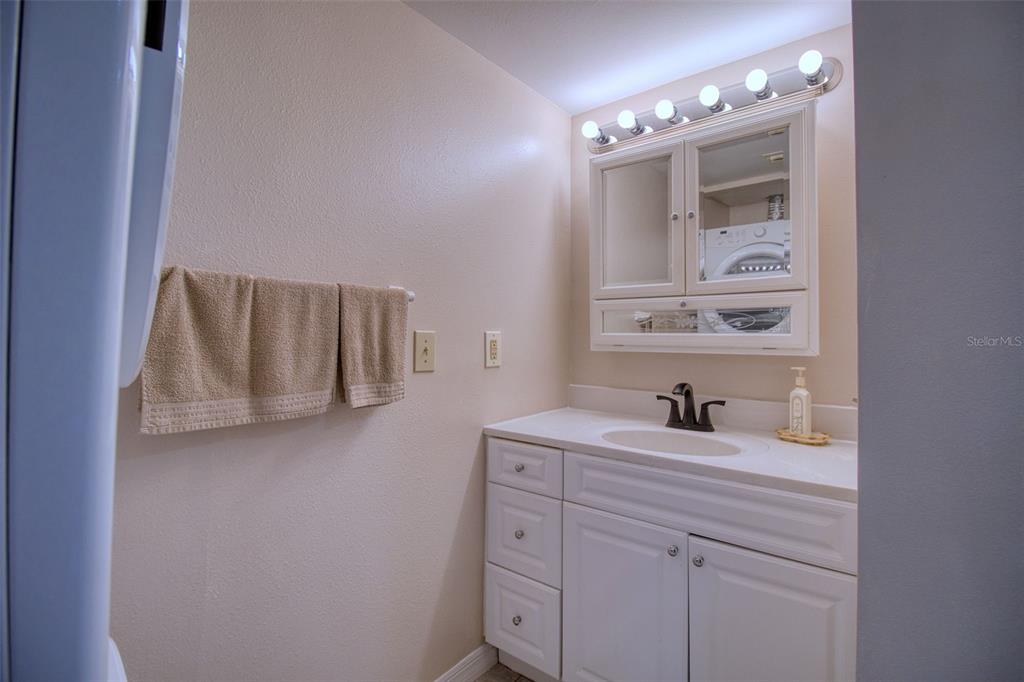 5915 Sea Ranch Drive, Unit 704 Hudson, FL 34667 - Photo 41 of 62 a bathroom with a sink and a mirror