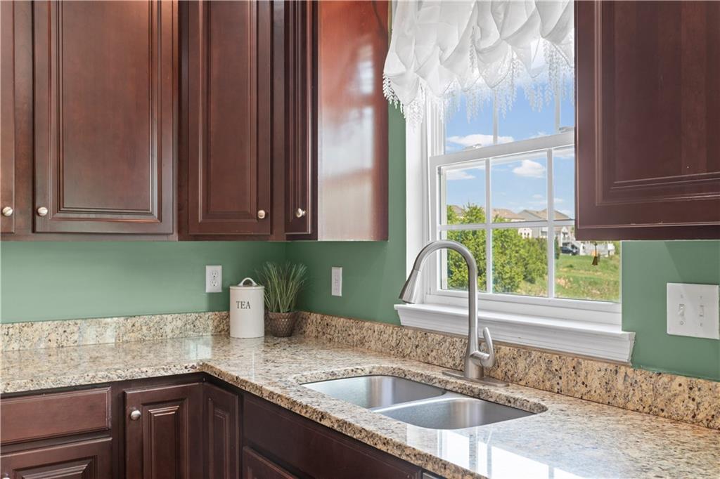 215 Long Ridge Drive Coraopolis, PA 15108 - Photo 11 of 50 a kitchen with granite countertop a sink and a wooden floor