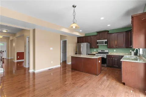 a view of a kitchen with a sink and a chandelier fan