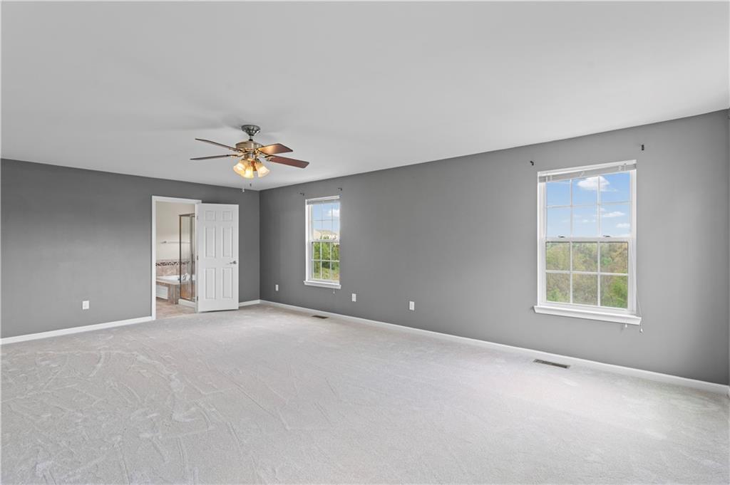 215 Long Ridge Drive Coraopolis, PA 15108 - Photo 34 of 50 an empty room with windows and chandelier fan