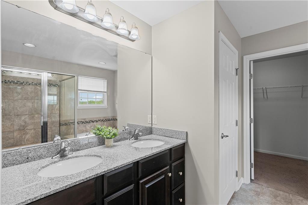 215 Long Ridge Drive Coraopolis, PA 15108 - Photo 35 of 50 a bathroom with a granite countertop sink a large mirror and a shower