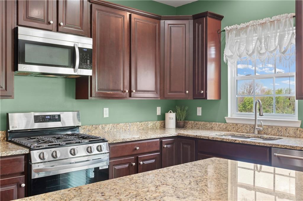 215 Long Ridge Drive Coraopolis, PA 15108 - Photo 8 of 50 a kitchen with stainless steel appliances granite countertop a stove a sink and a microwave