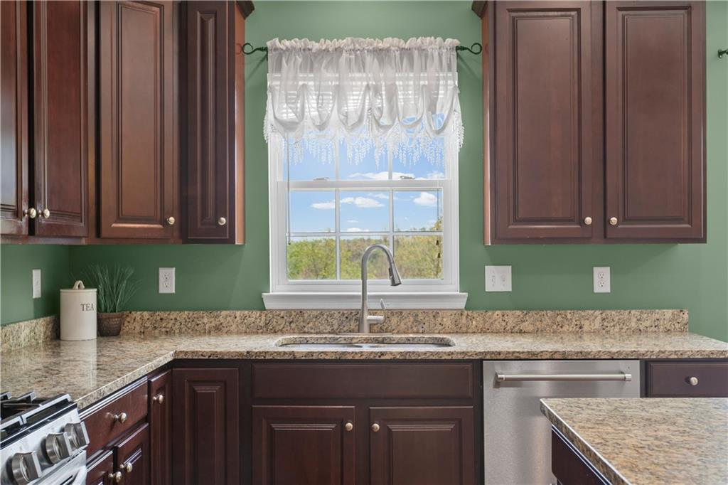 215 Long Ridge Drive Coraopolis, PA 15108 - Photo 10 of 50 a kitchen with stainless steel appliances granite countertop a sink and a stove
