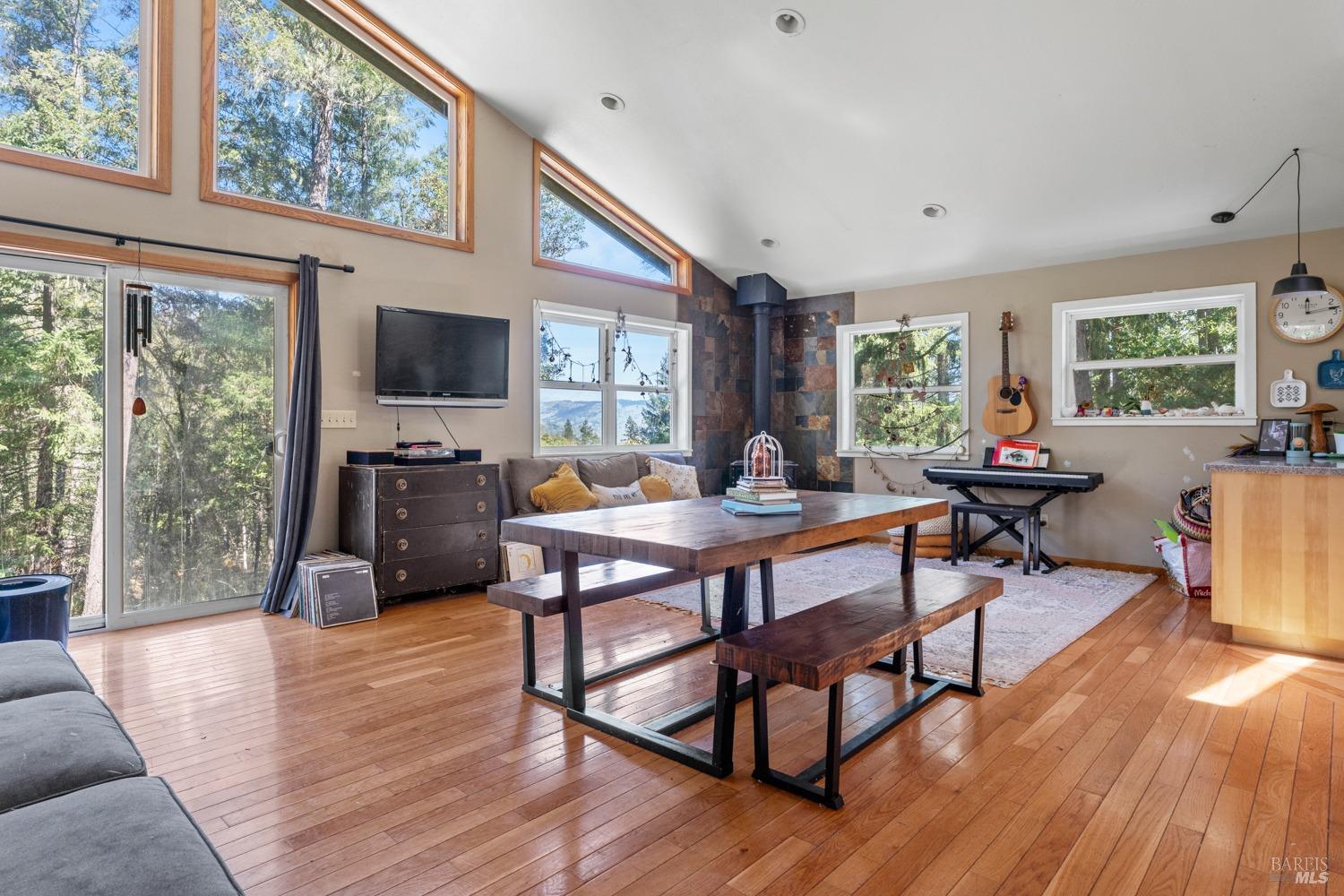 a living room with furniture a flat screen tv and a large window