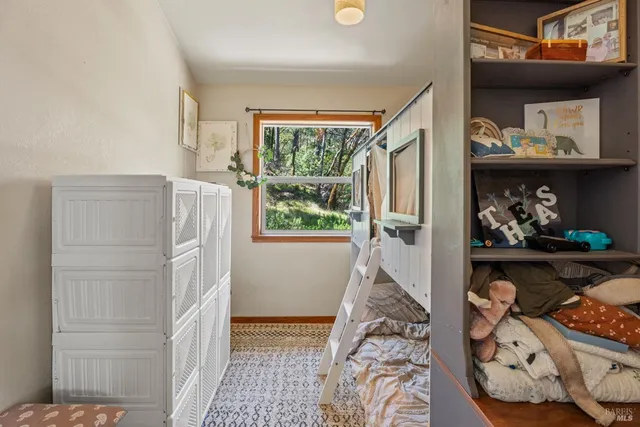 a view of bedroom with furniture and a window
