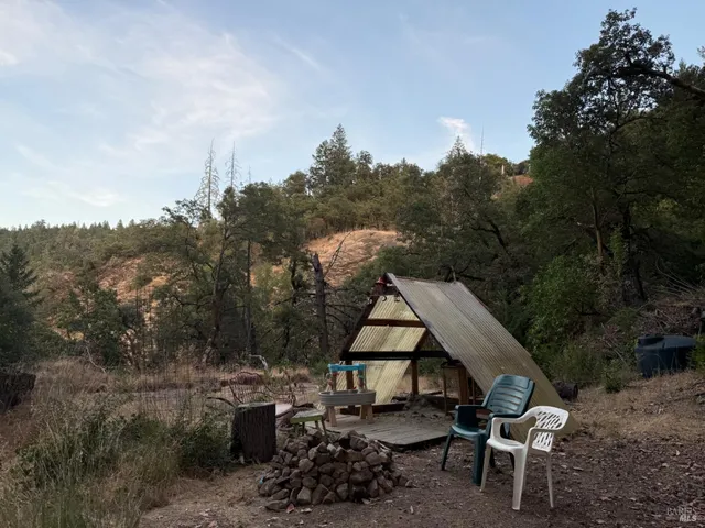 a view of backyard with patio and outdoor seating