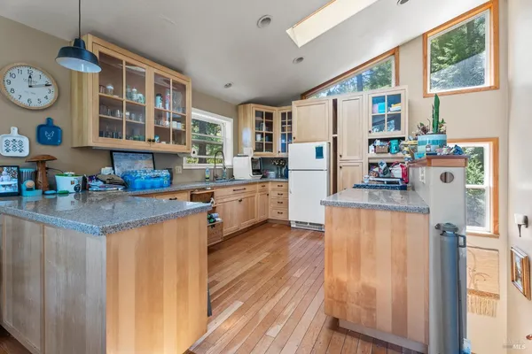 a kitchen with stainless steel appliances granite countertop a refrigerator and a stove top oven
