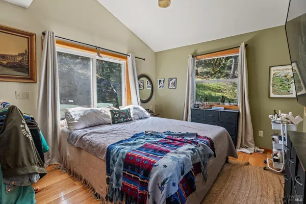 a bedroom with a bed next to a window