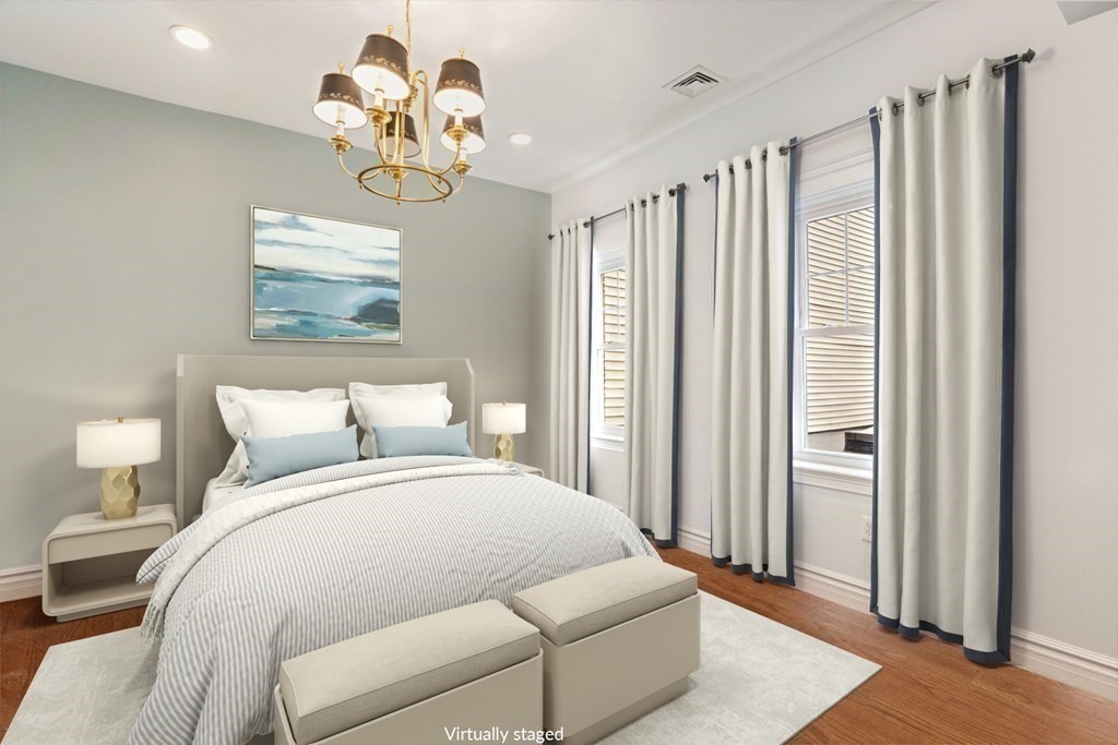 50 Baldwin Street Boston, MA 02129 - Photo 12 of 24 a bedroom with a bed and a chandelier