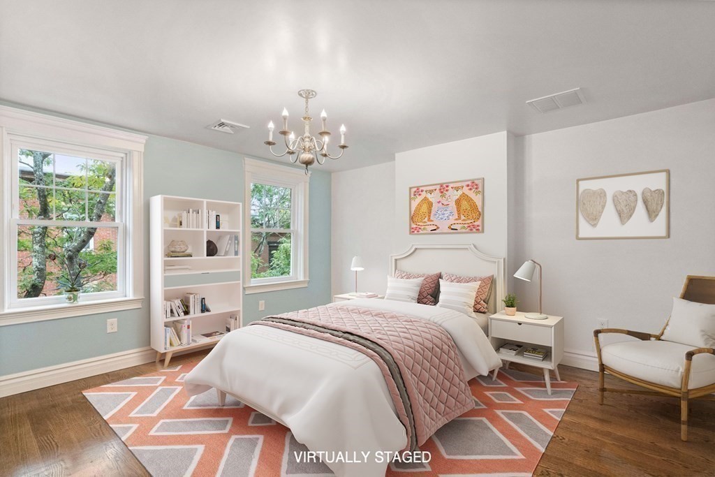 50 Baldwin Street Boston, MA 02129 - Photo 15 of 24 a spacious bedroom with a bed a chandelier and a window