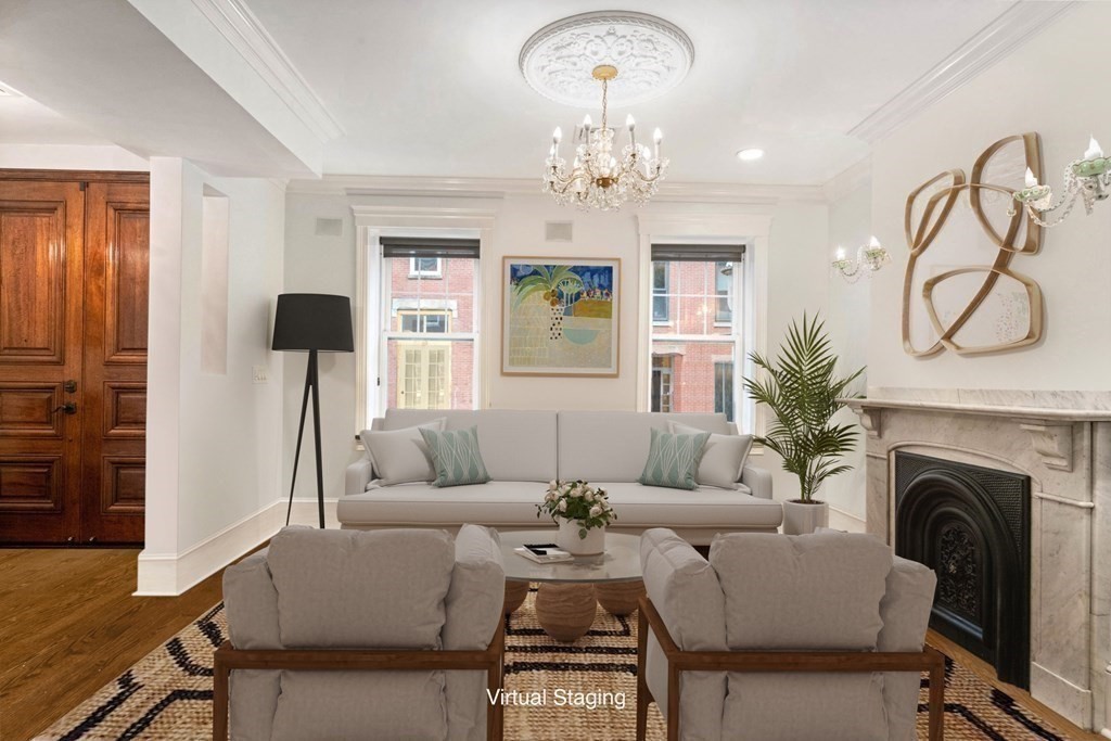 50 Baldwin Street Boston, MA 02129 - Photo 2 of 24 a living room with furniture a fireplace and a chandelier