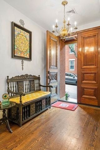 a bedroom with bed and a chandelier