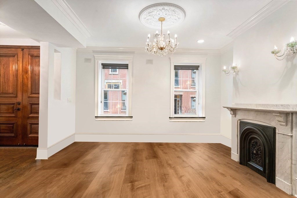 50 Baldwin Street Boston, MA 02129 - Photo 3 of 24 a view of a livingroom with a fireplace wooden floor and windows