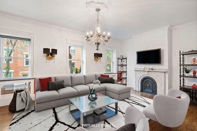 a living room with furniture a flat screen tv and a fireplace