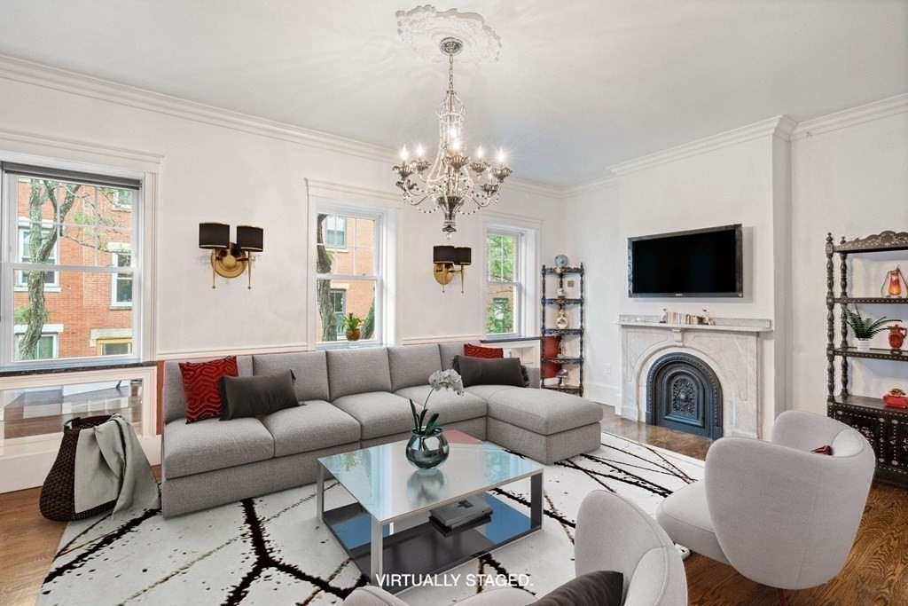 50 Baldwin Street Boston, MA 02129 - Photo 4 of 24 a living room with furniture a flat screen tv and a fireplace