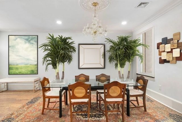 a view of a dining room with furniture and a chandelier